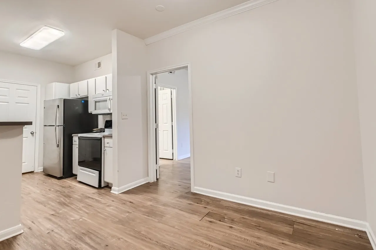 Kitchen and living area, wood-style plank flooring, stainless appliances, open concept layout
