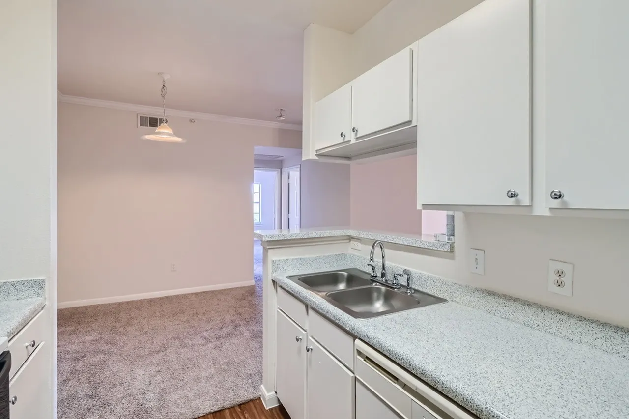 Kitchen, white shaker cabinetry, quartz countertops, stainless steel sink, wood-style plank flooring, open floor plan