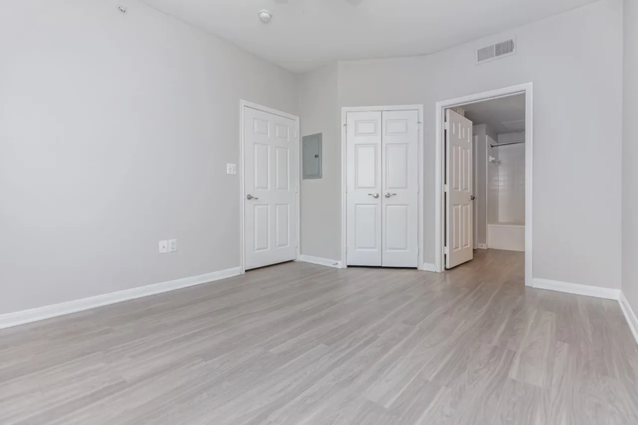 Bedroom, wood-style plank flooring, white interior doors, double closet doors, ceiling vent