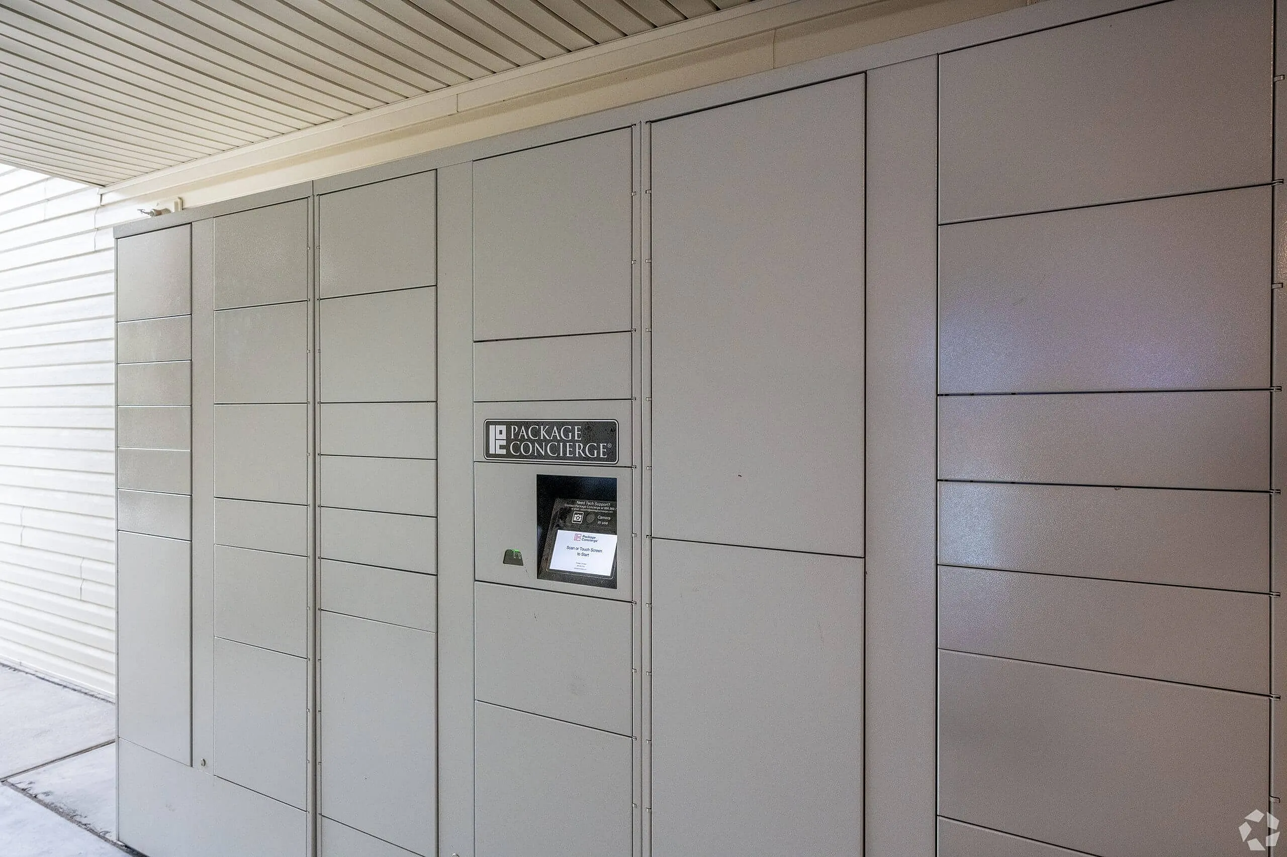Parcel locker wall, stacked compartments, gray finish, concierge kiosk