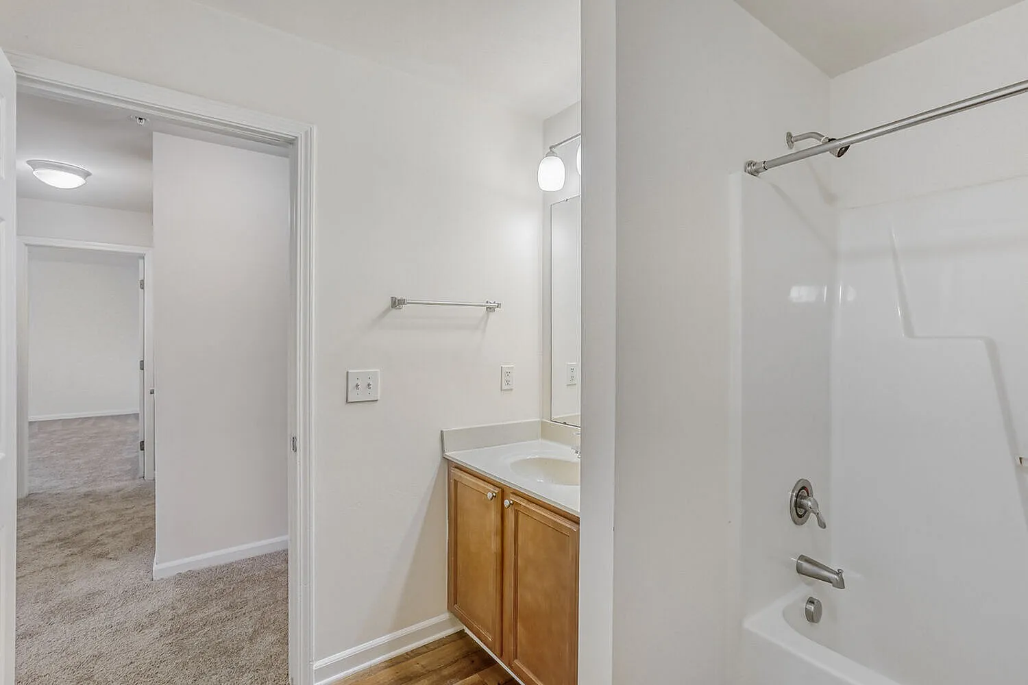 Bathroom, wood vanity cabinet, white subway tile shower, glass enclosure