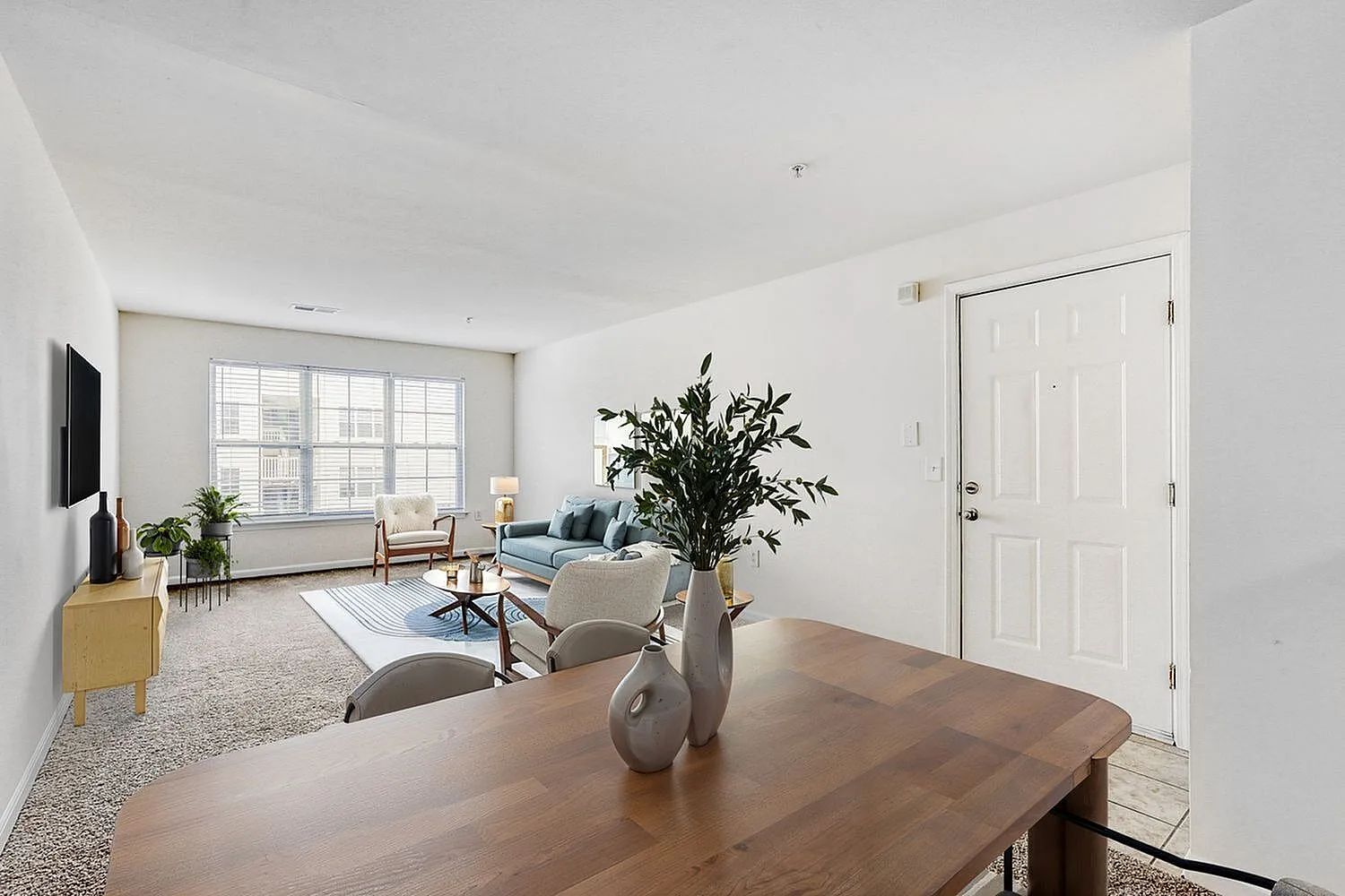Dining and living room, wood-style plank flooring, large windows, potted plants