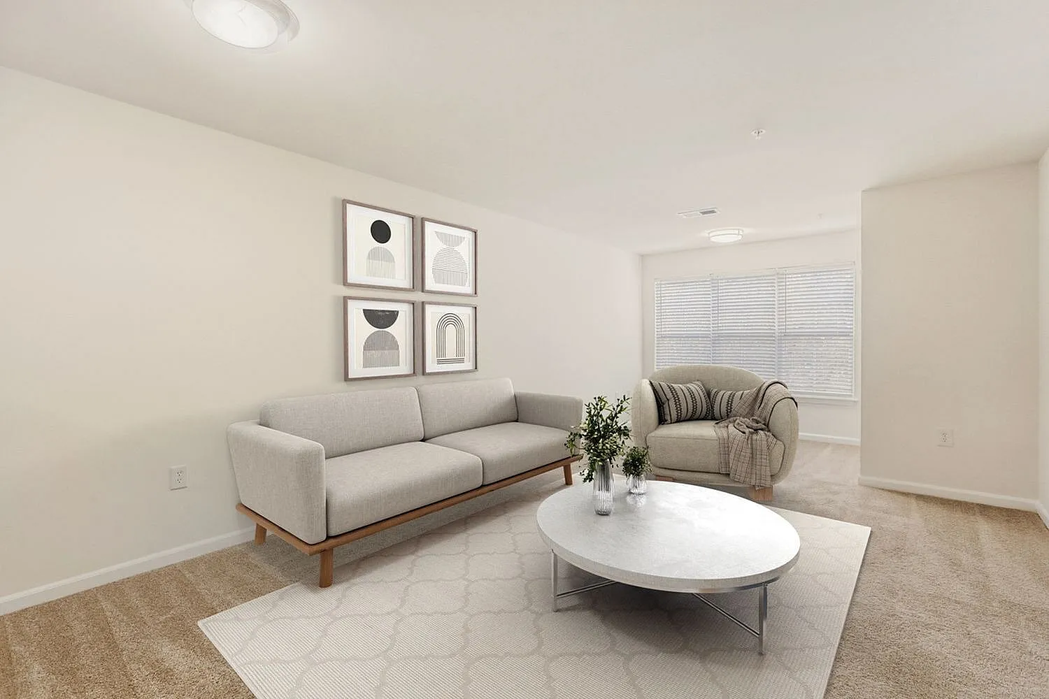 Living room, gray sofa, striped armchair, white oval coffee table, wood-style plank flooring, geometric wall art