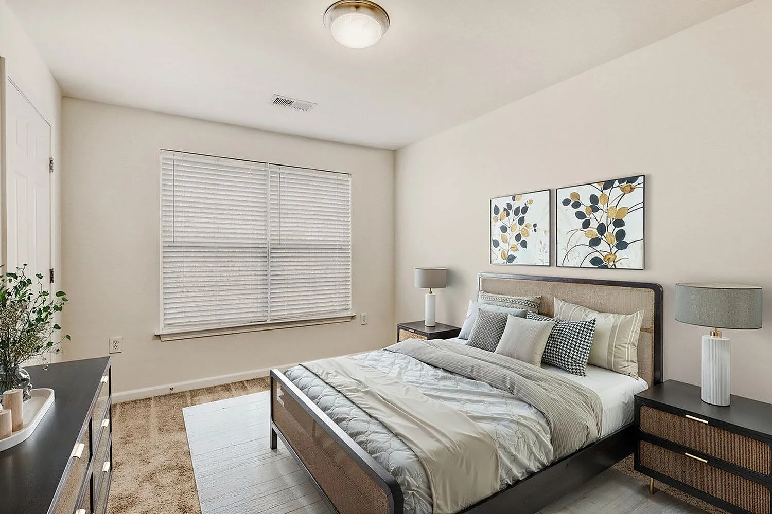 Primary bedroom, wood-style plank flooring, upholstered headboard, botanical wall art