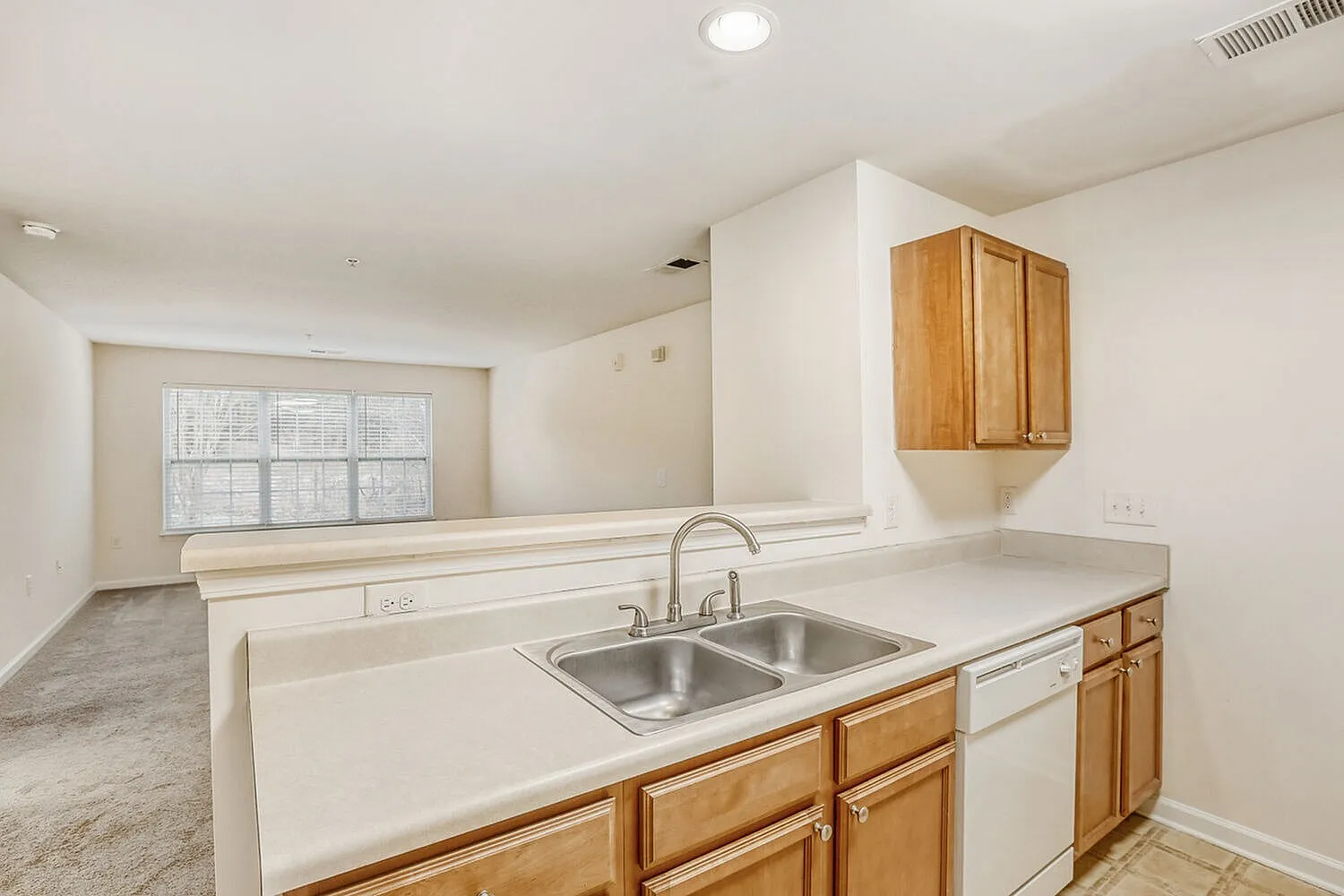 Kitchen, wood cabinetry, white countertops, stainless steel sink, wood-style plank flooring