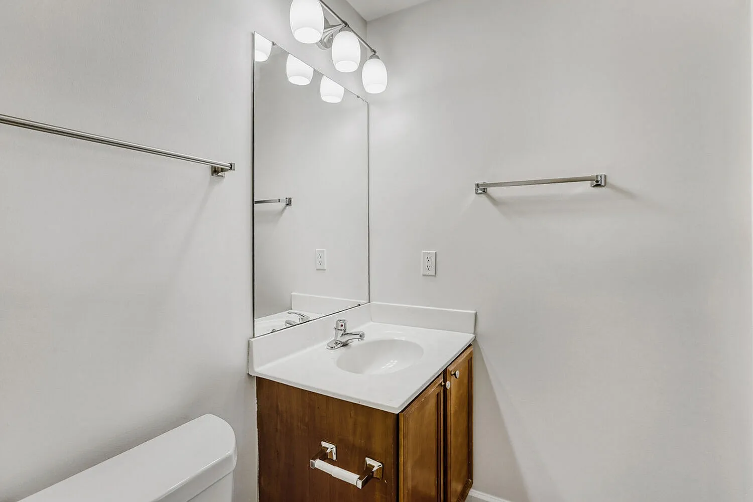 Bathroom, wood vanity, white countertop, glass mirror, vessel sink