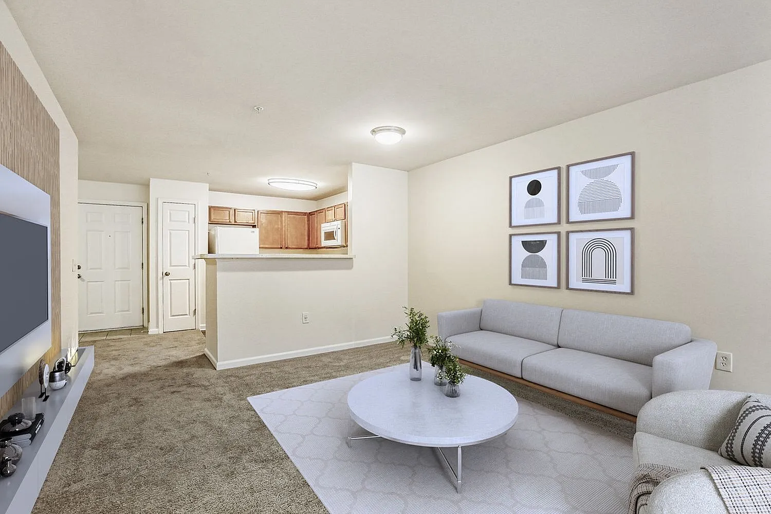 Living room with gray sofa, wood-style plank flooring, white coffee table, abstract wall art