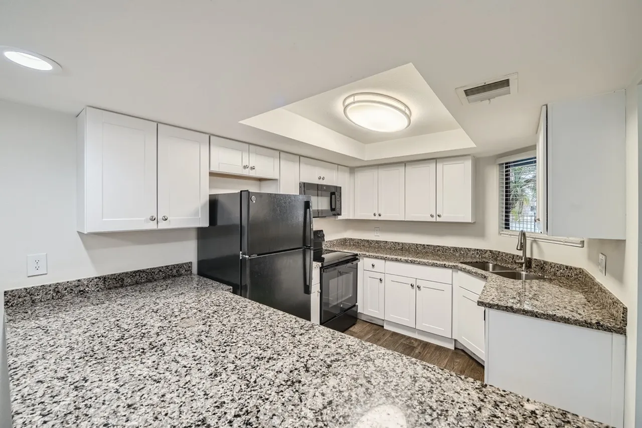 Kitchen, white shaker cabinetry, granite countertops, black stainless appliances, recessed lighting