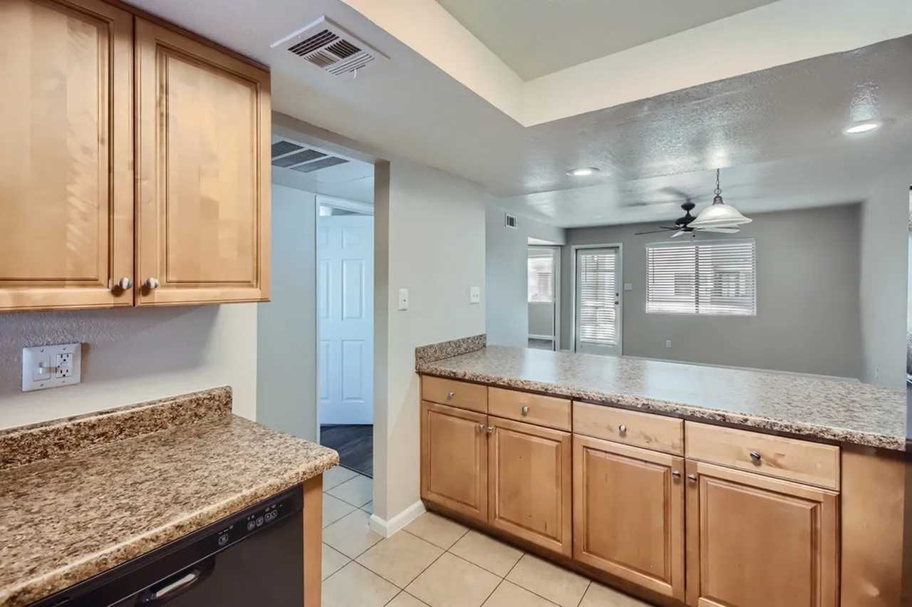 Kitchen, light wood cabinetry, granite countertops, stainless appliances, tile flooring
