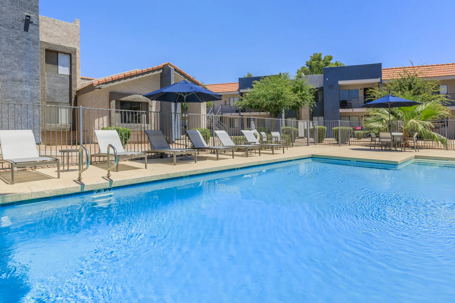 Pool deck with lounge seating and dining area