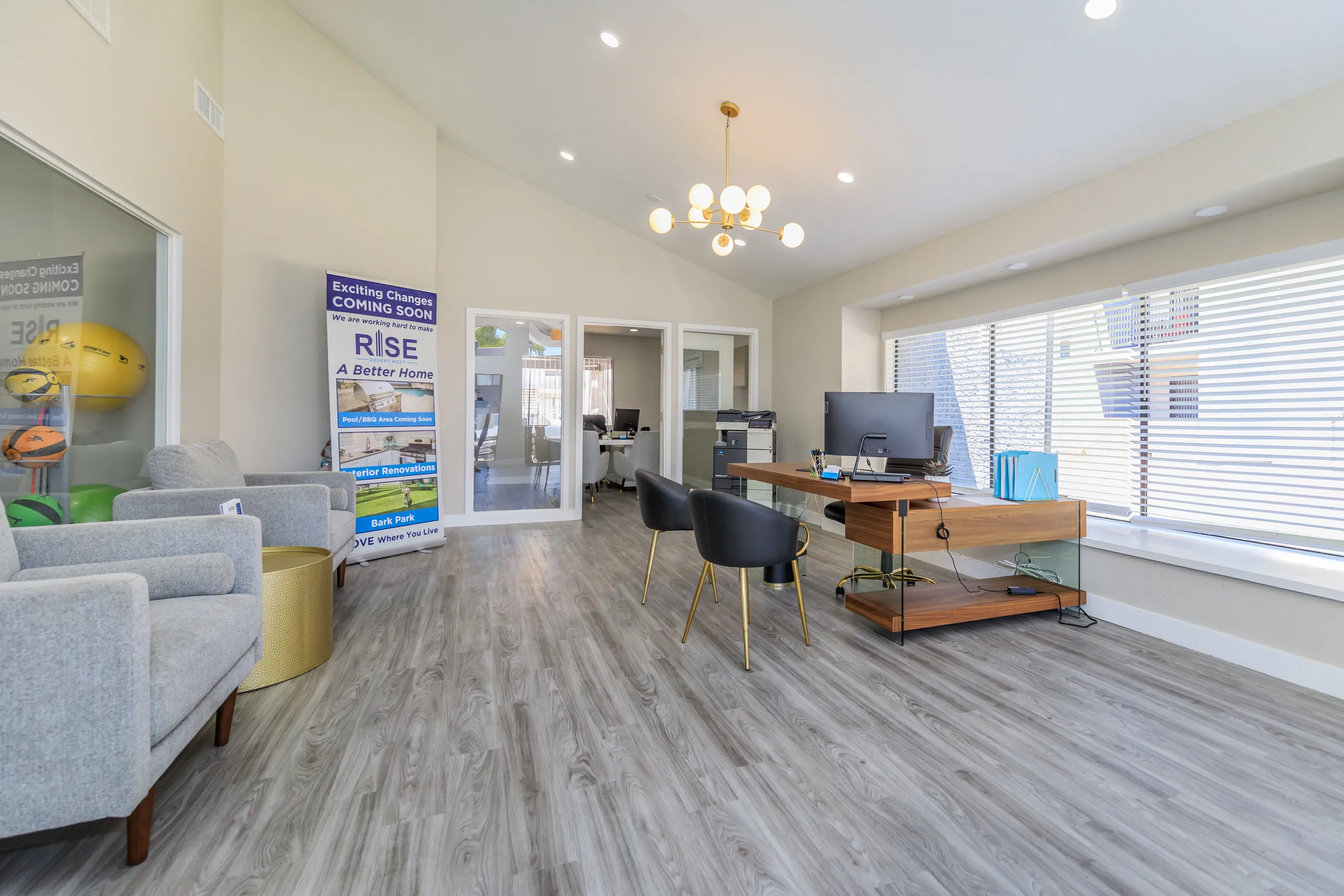 Leasing office lounge with guest seating and agent desk