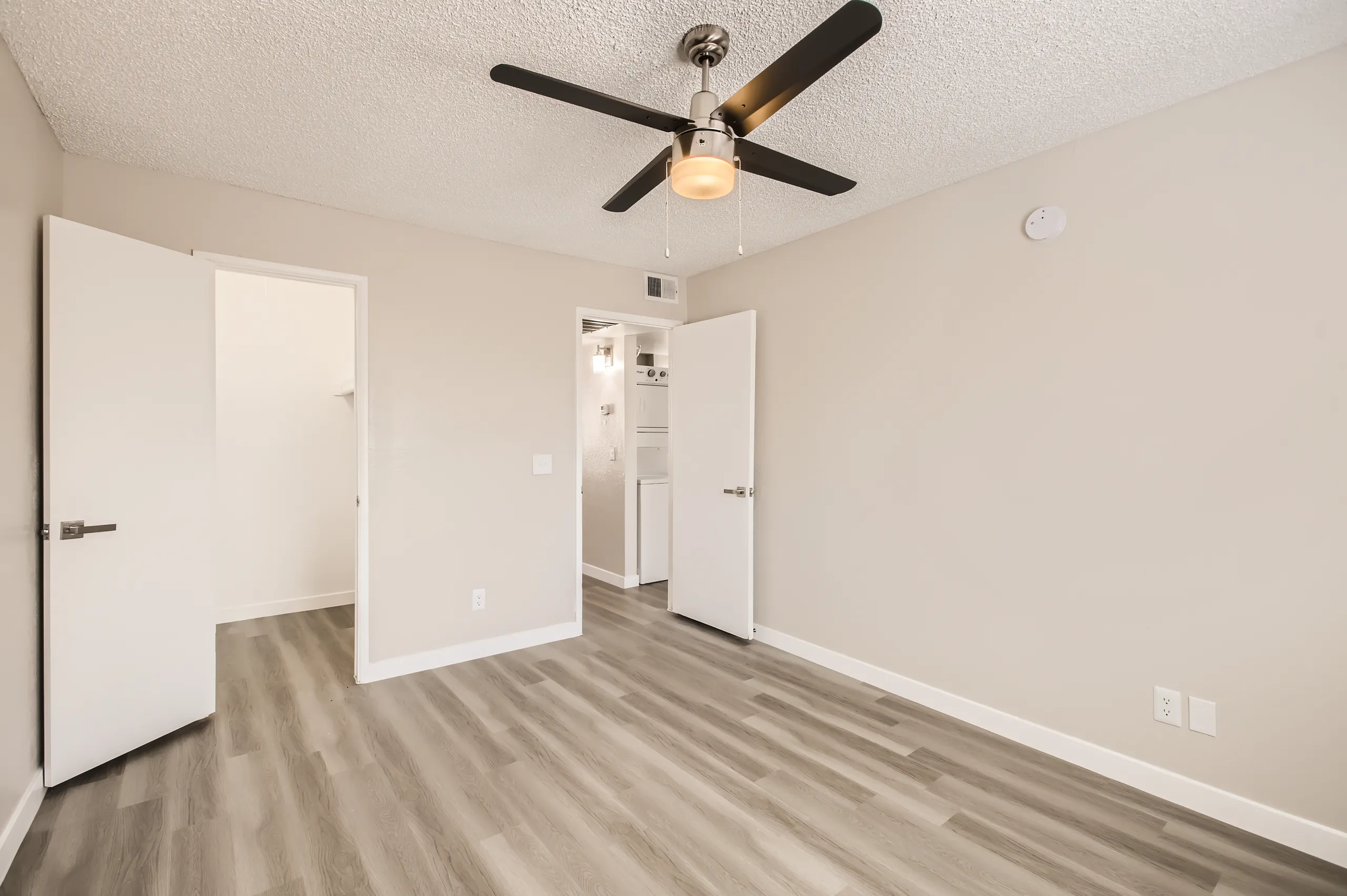 Primary bedroom with closet and door leading to bathroom