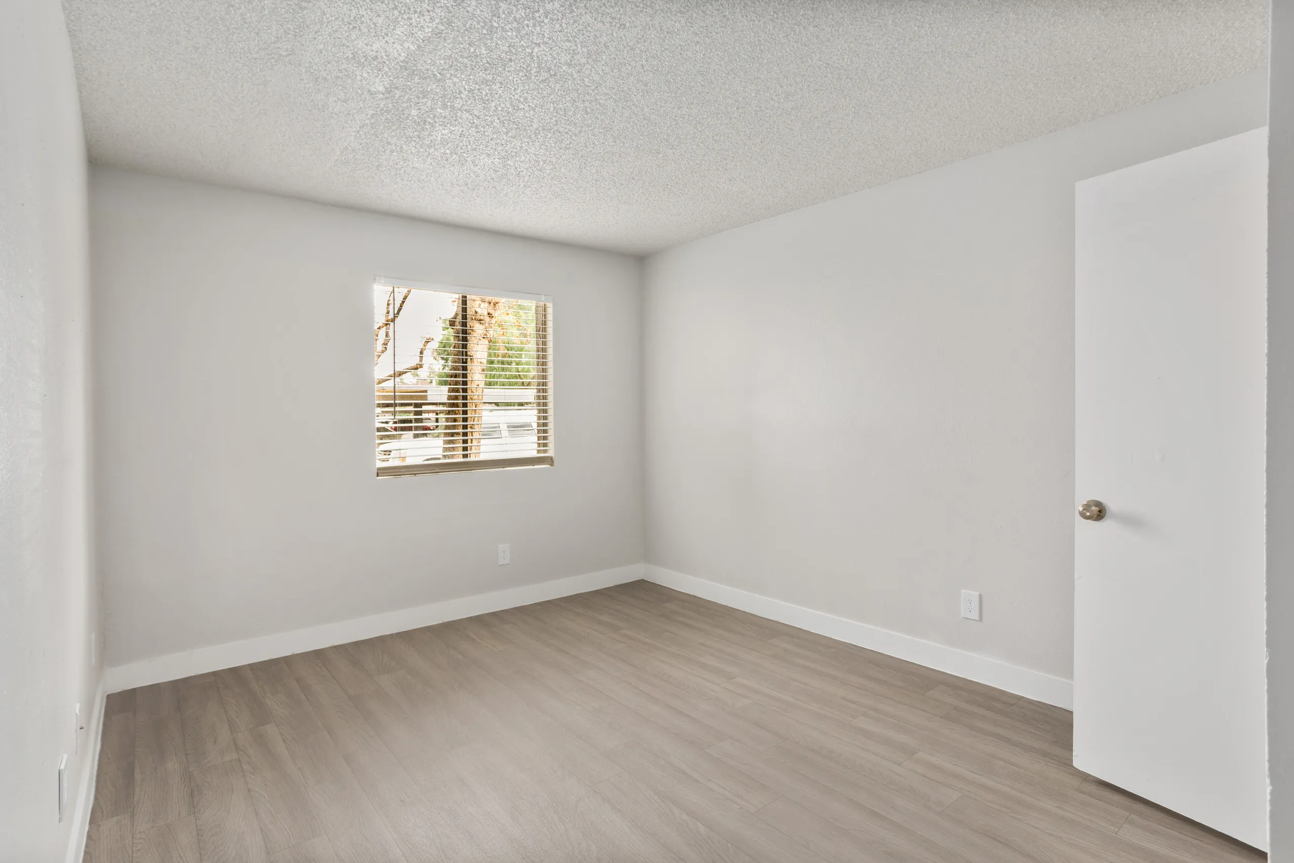 Bedroom with window and wood-style flooring