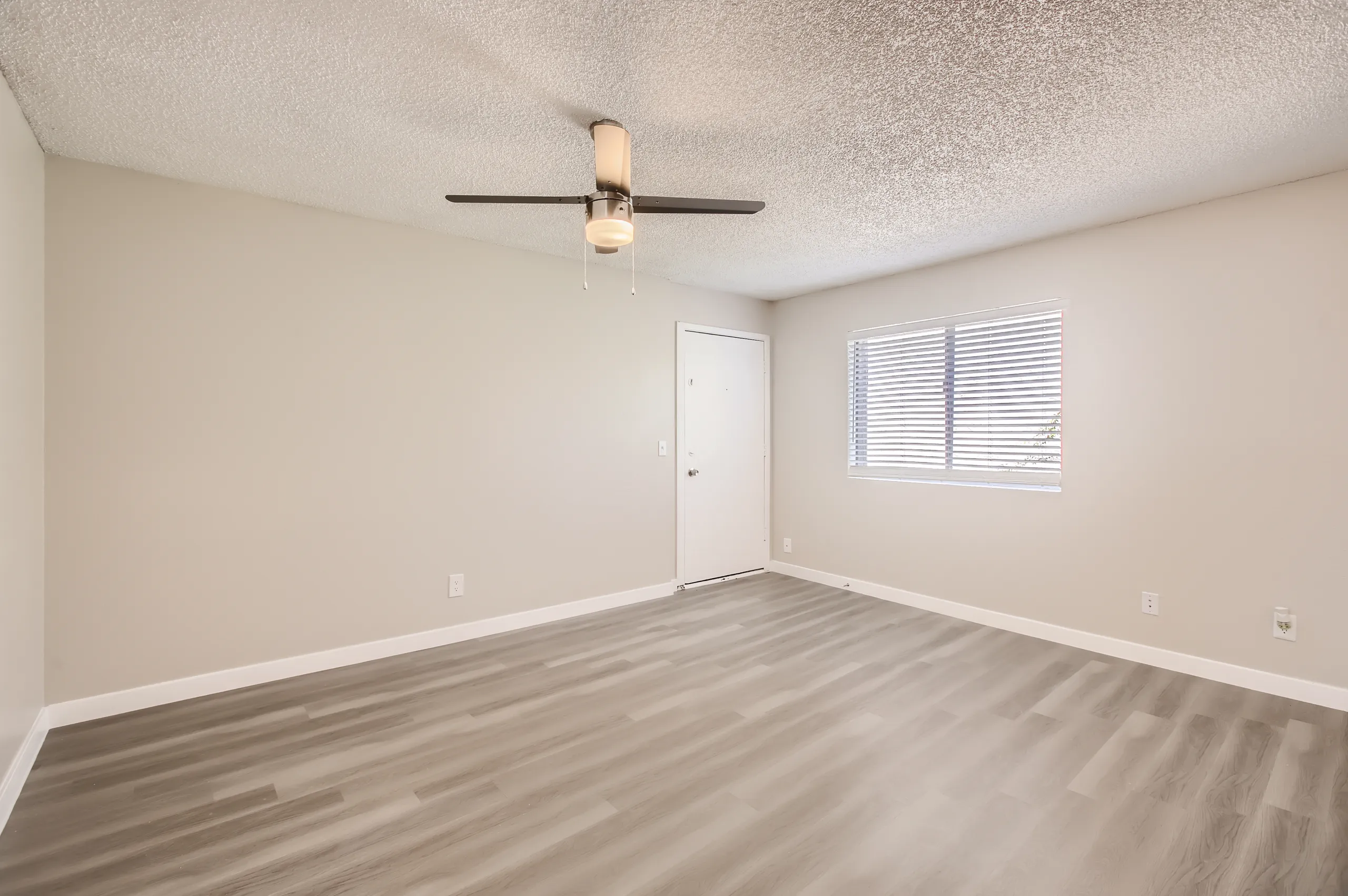 Living room with entry door and window