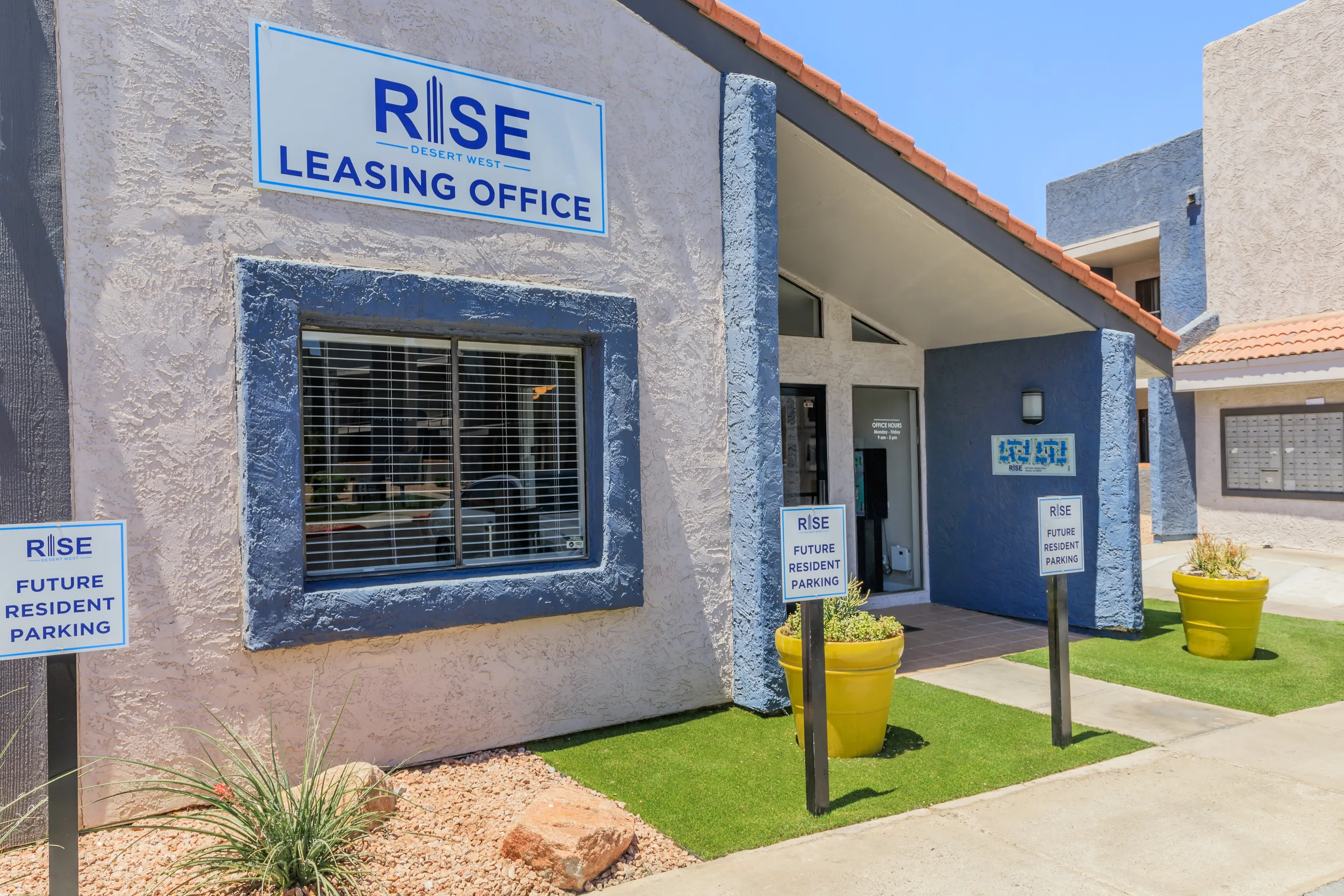 Leasing office entrance with signage and visitor parking