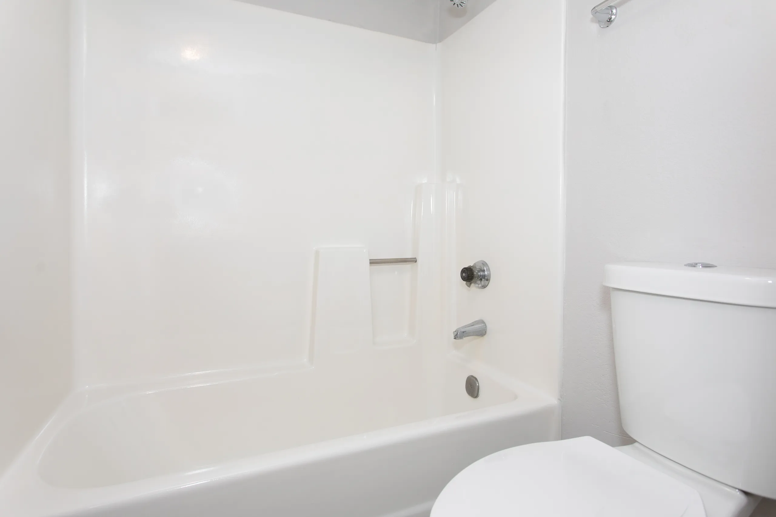 Bathroom with soaking tub and tiled surround