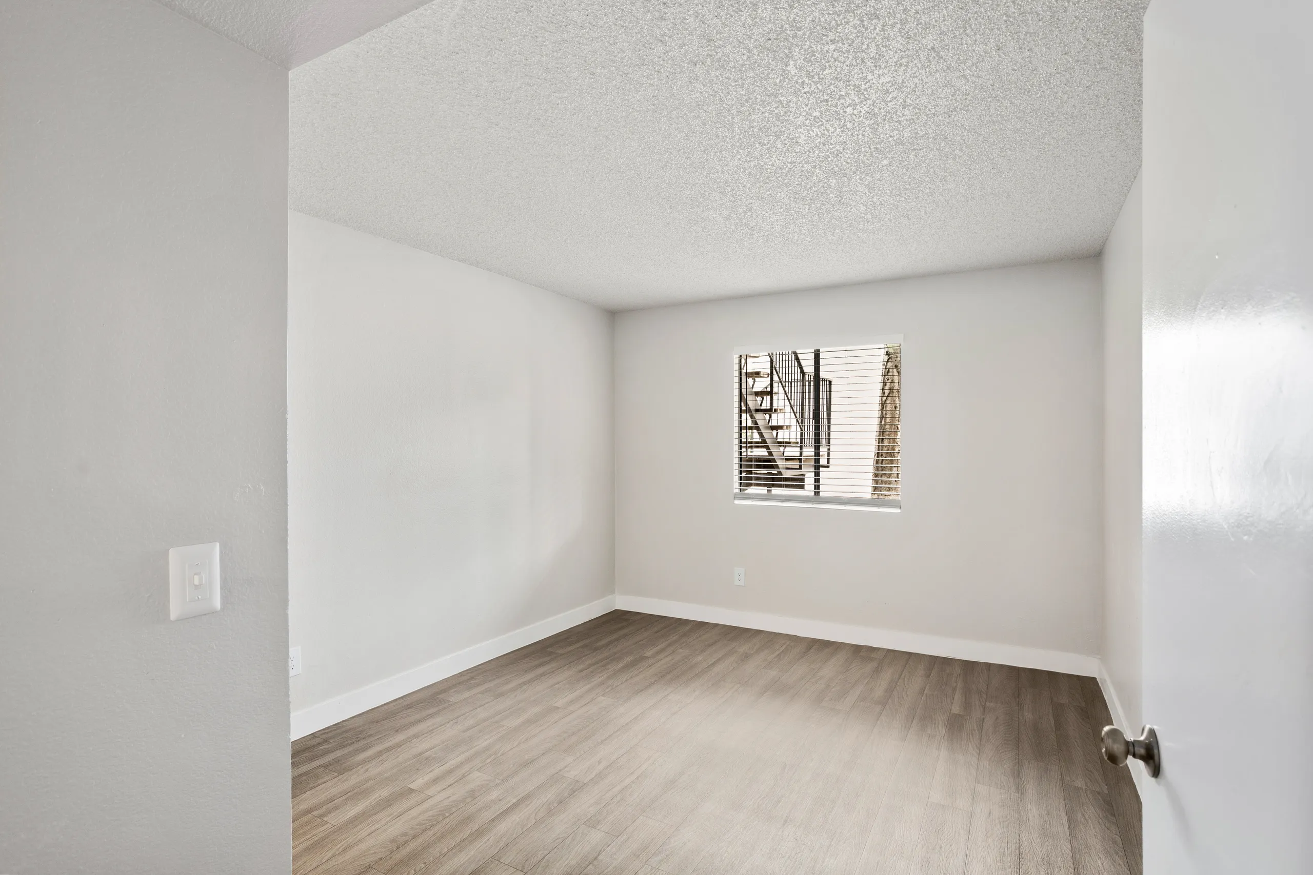 Bedroom with window and wood-style flooring