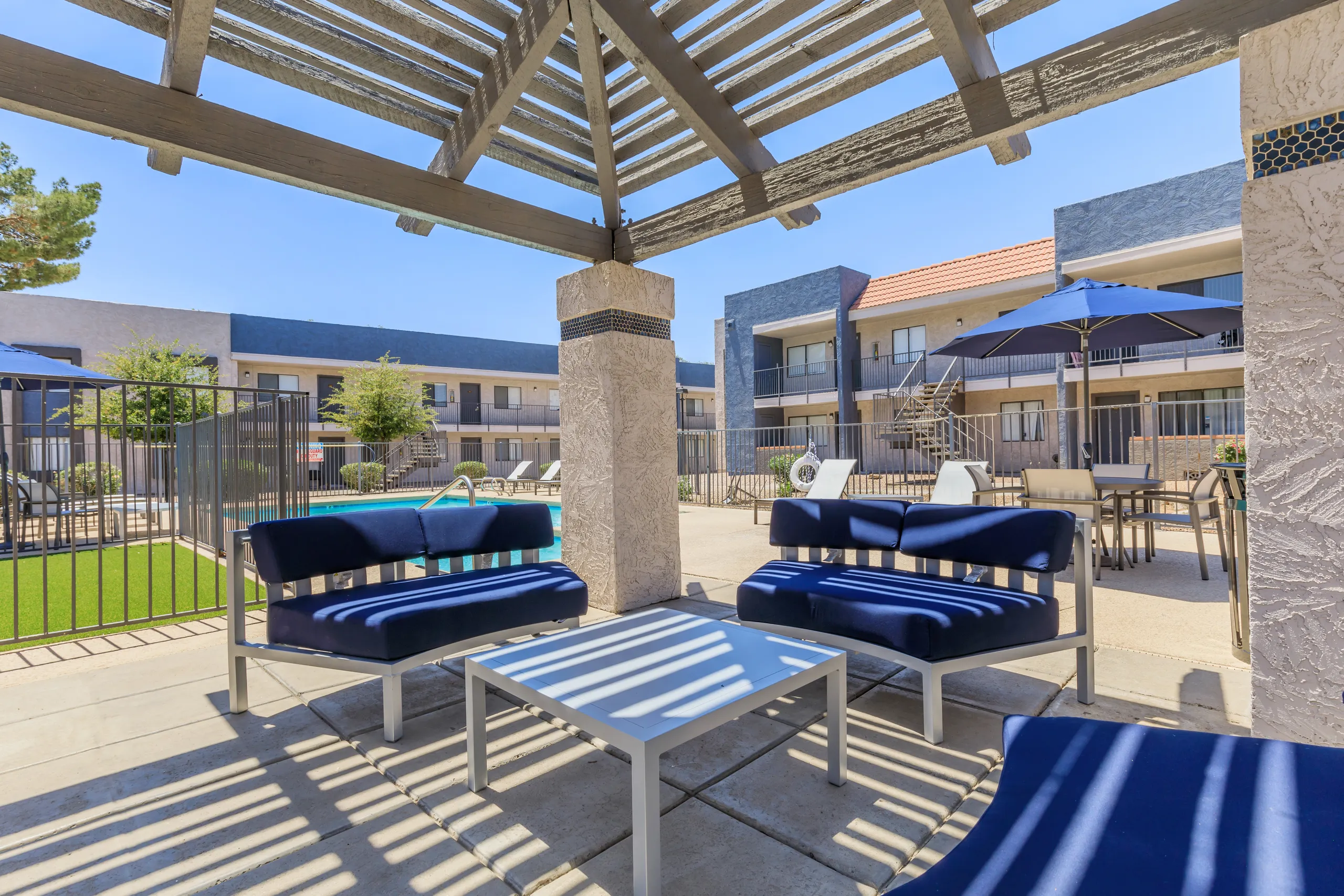 Pergola lounge seating overlooking the pool