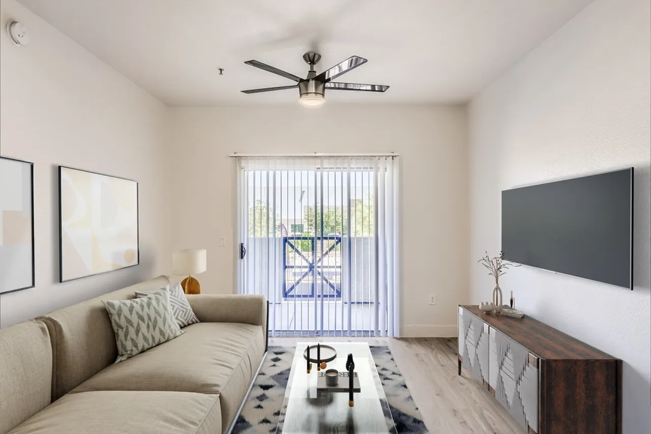 Living room, wood-style plank flooring, ceiling fan, flat-screen TV, sofa