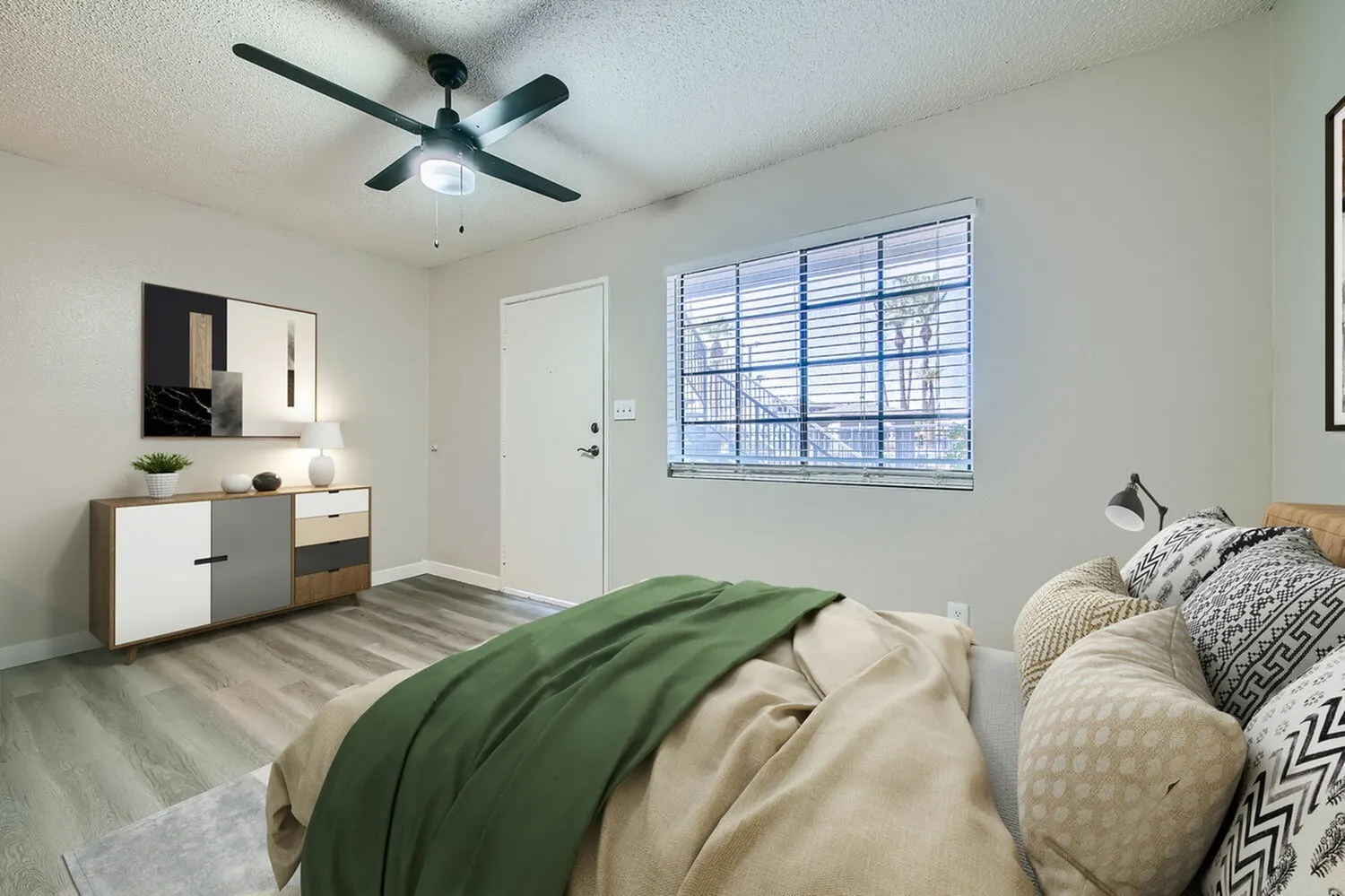 Primary bedroom, wood-style plank flooring, ceiling fan with light, horizontal blinds window
