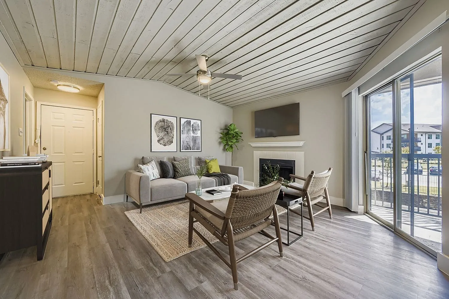 Living room, fireplace, plank ceiling, sliding glass door, wood-style plank flooring