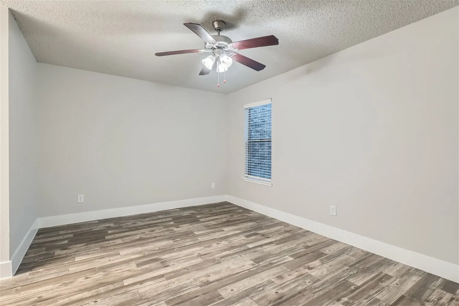 Bedroom, ceiling fan, window with blinds, wood-style plank flooring