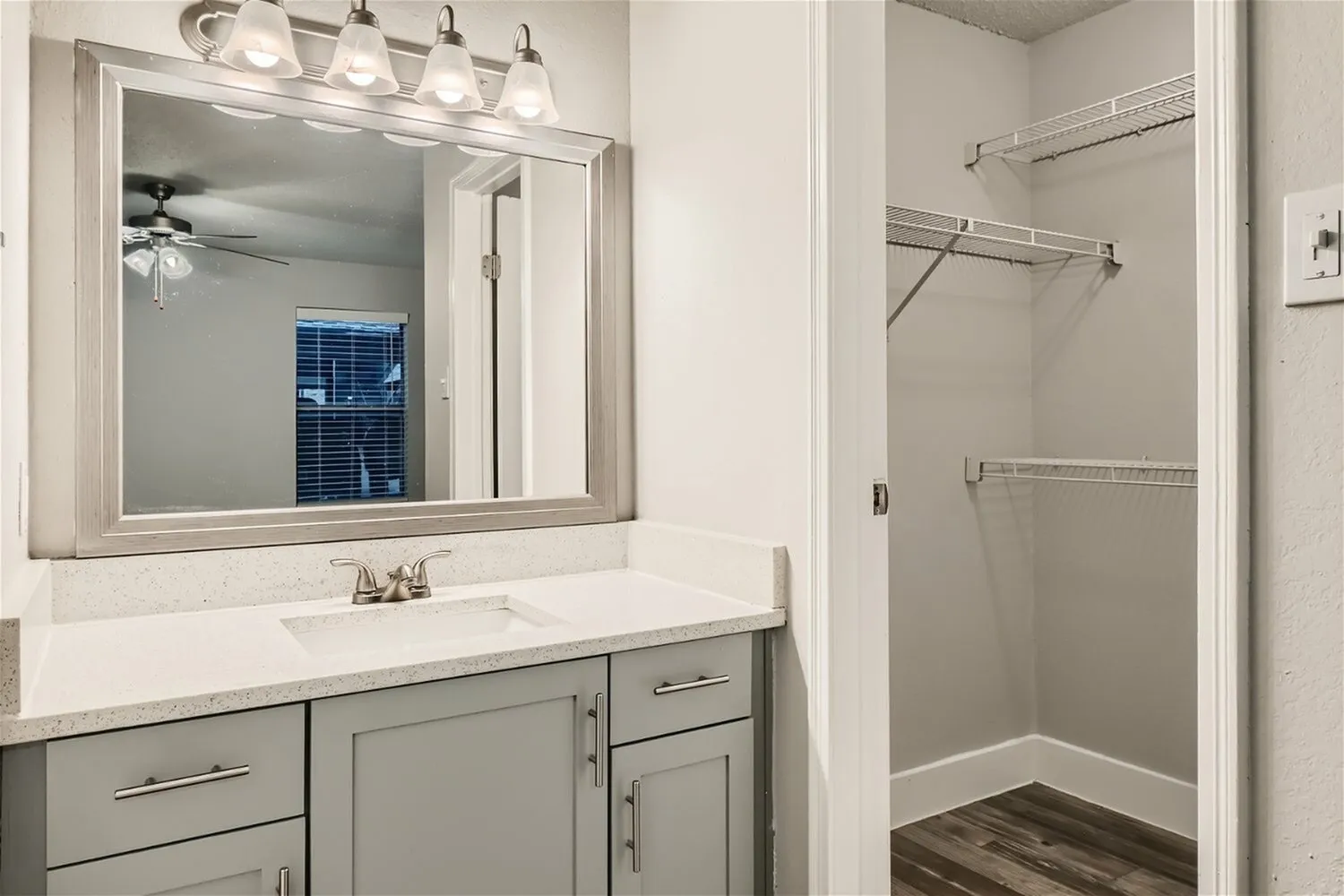 Bathroom vanity, framed mirror, walk-in closet, wire shelving