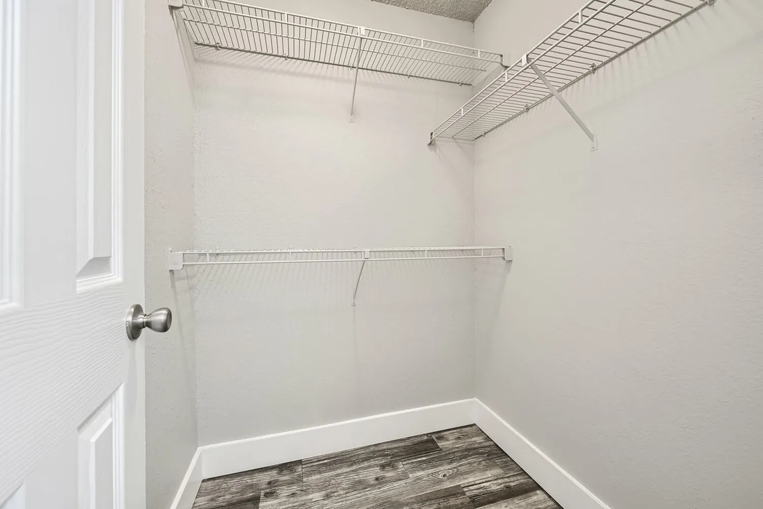 Walk-in closet, wire shelving, hanging rods