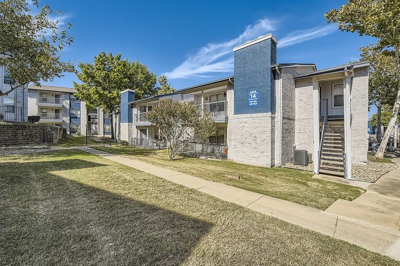 Apartment building exterior, blue accent tower, exterior stairs, walkway, lawn