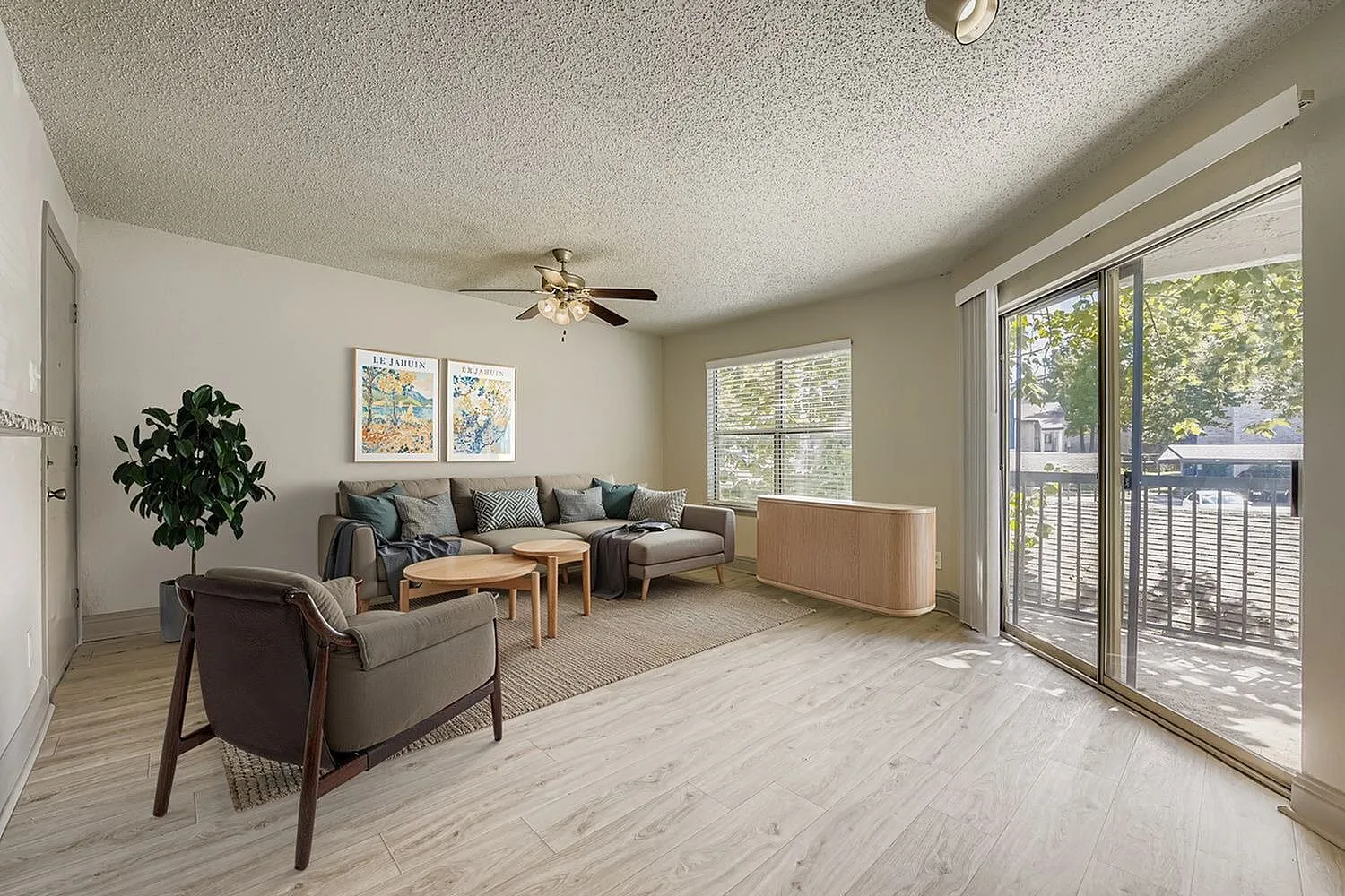 A1 Bronze living room, ceiling fan, window, sliding glass door, wood-style plank flooring