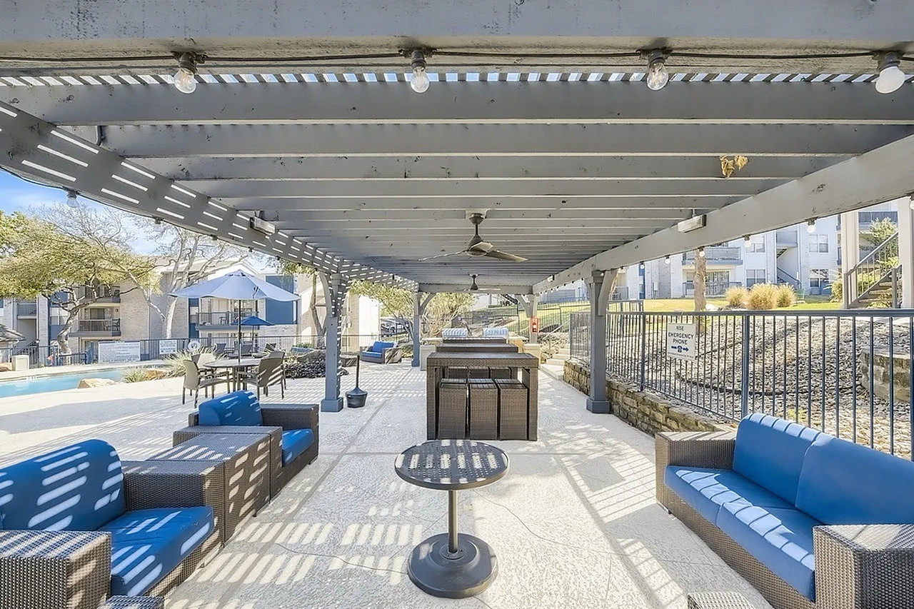 Covered pergola, ceiling fans, lounge seating, bar-height table