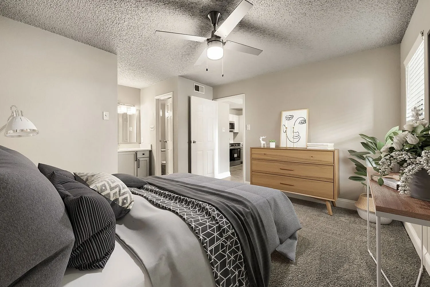 Bedroom, ceiling fan, carpet flooring, doorway to bathroom, hallway view