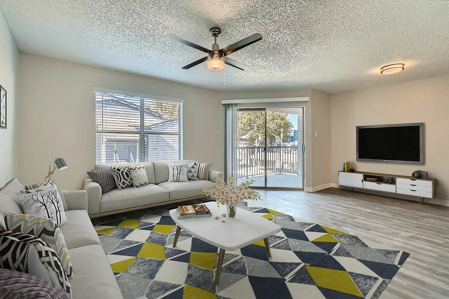 B1 Platinum living room, ceiling fan, sliding glass door to balcony, window with horizontal blinds, wood-style plank flooring