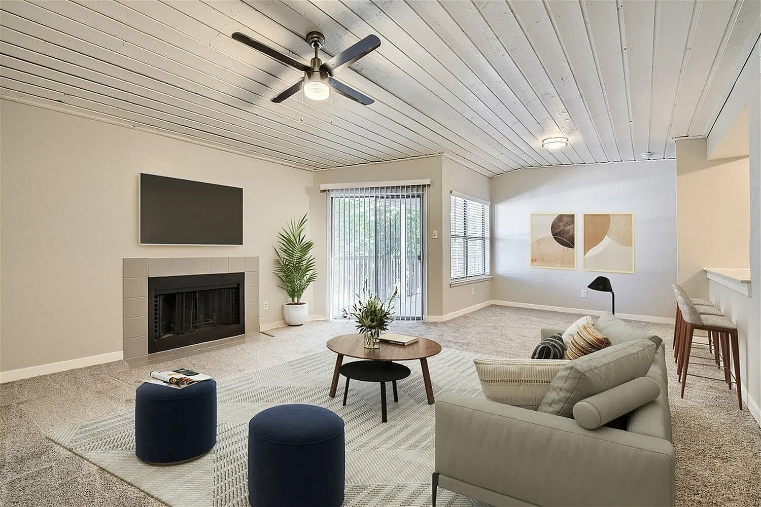 B2 Platinum living room, fireplace, plank ceiling, sliding glass door, carpet flooring