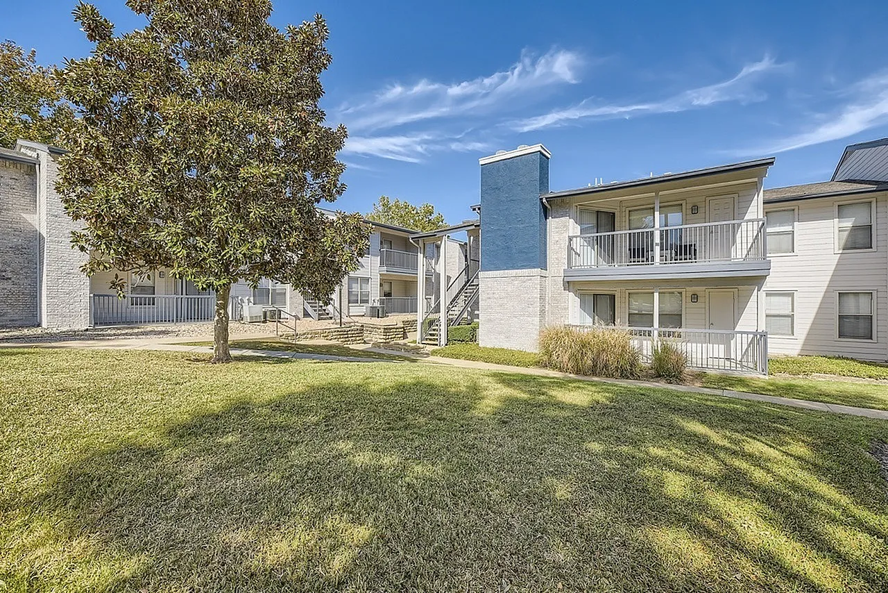 Courtyard lawn, blue accent tower, balconies, mature tree