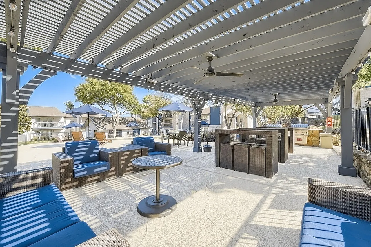 Covered pergola, ceiling fan, outdoor seating, grilling stations