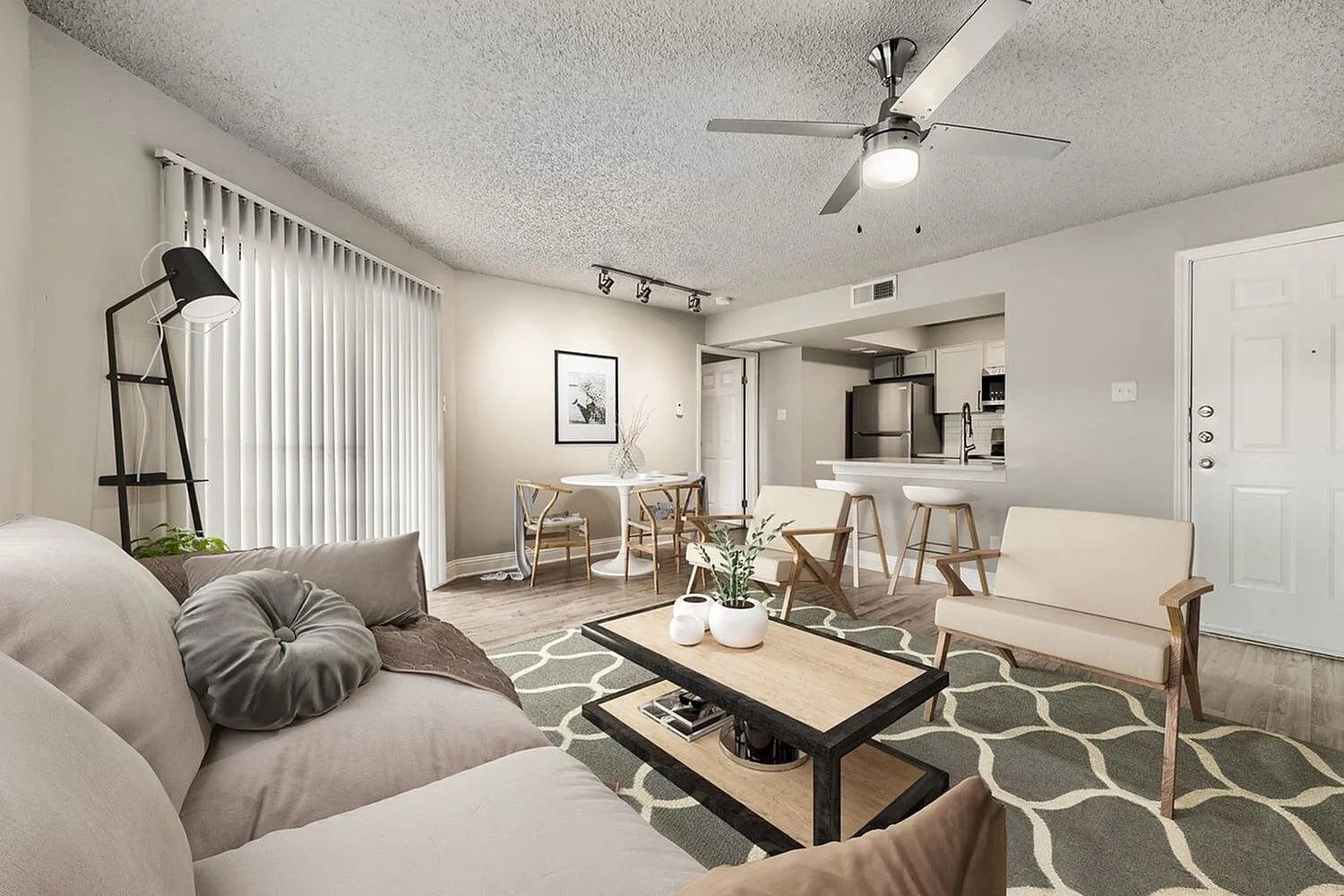 Open living area, vertical blinds, track lighting, breakfast bar, dining area