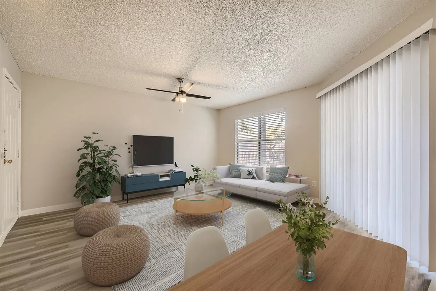 Living room, ceiling fan, window with vertical blinds, textured ceiling