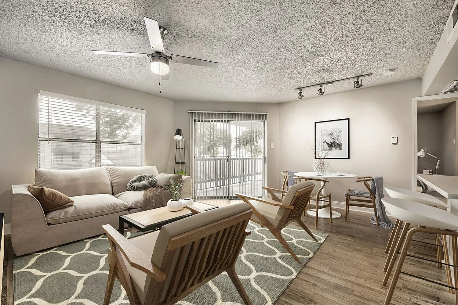 A1 Gold living and dining area, ceiling fan, track lighting, sliding glass door, wood-style plank flooring