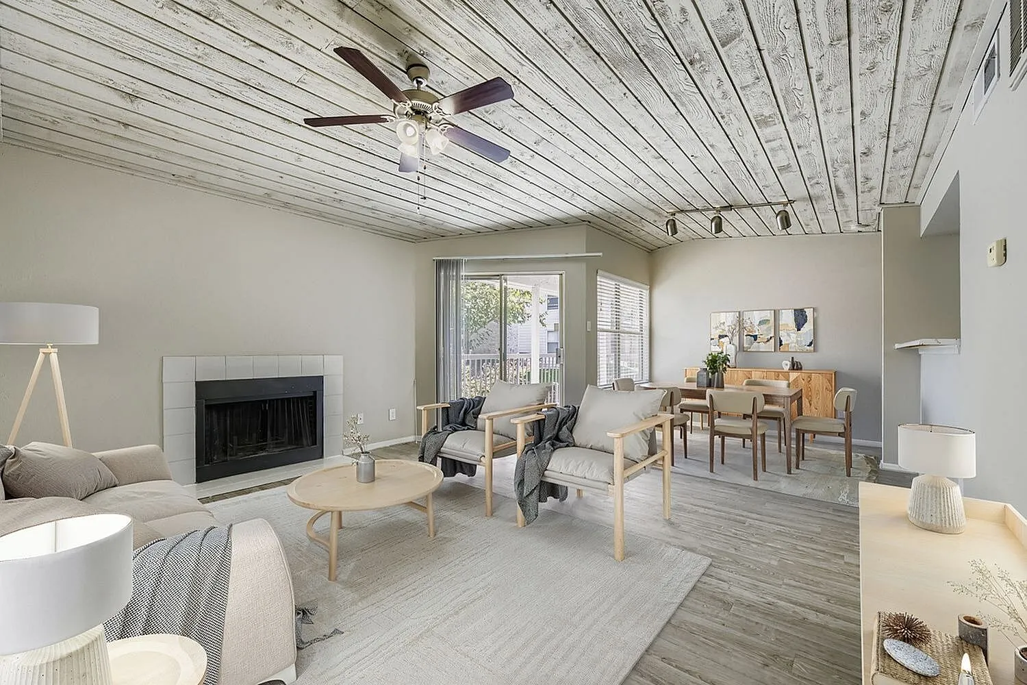 B2 Silver living and dining area, fireplace, plank ceiling, ceiling fan, sliding glass door, wood-style plank flooring