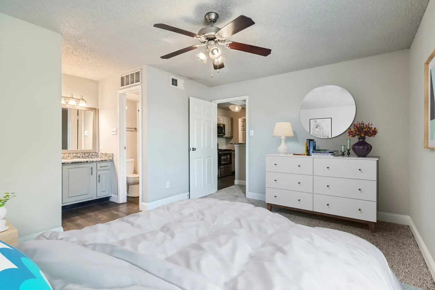 Bedroom, ceiling fan, doorway to bathroom, view to kitchen