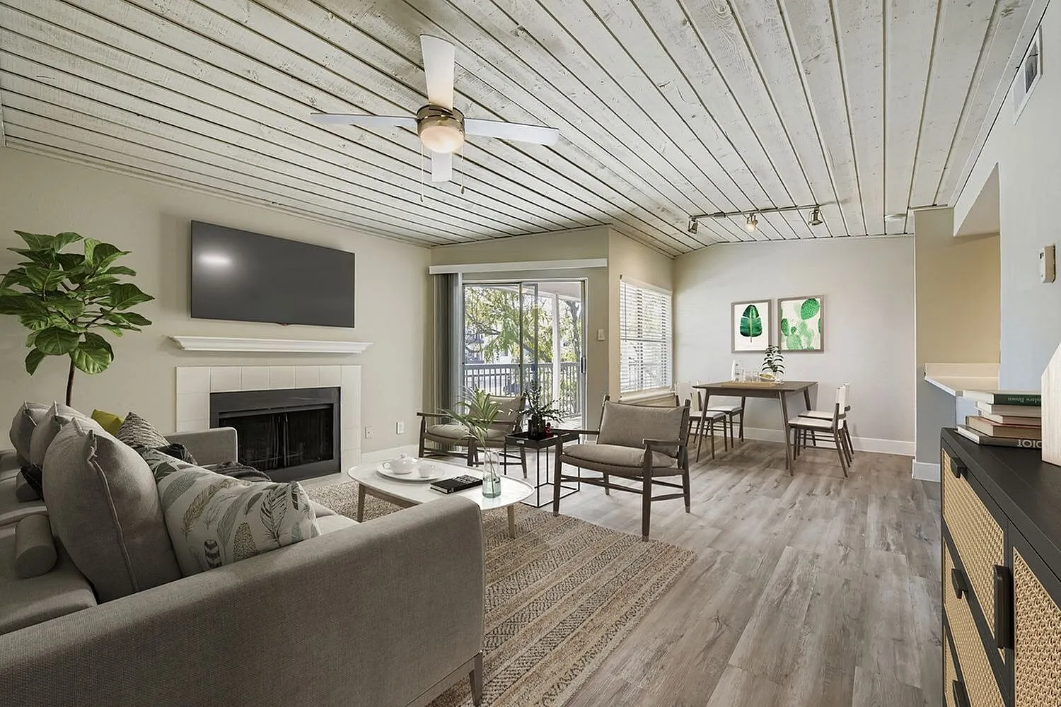 B2 Gold living and dining area, fireplace, plank ceiling, ceiling fan, track lighting, wood-style plank flooring