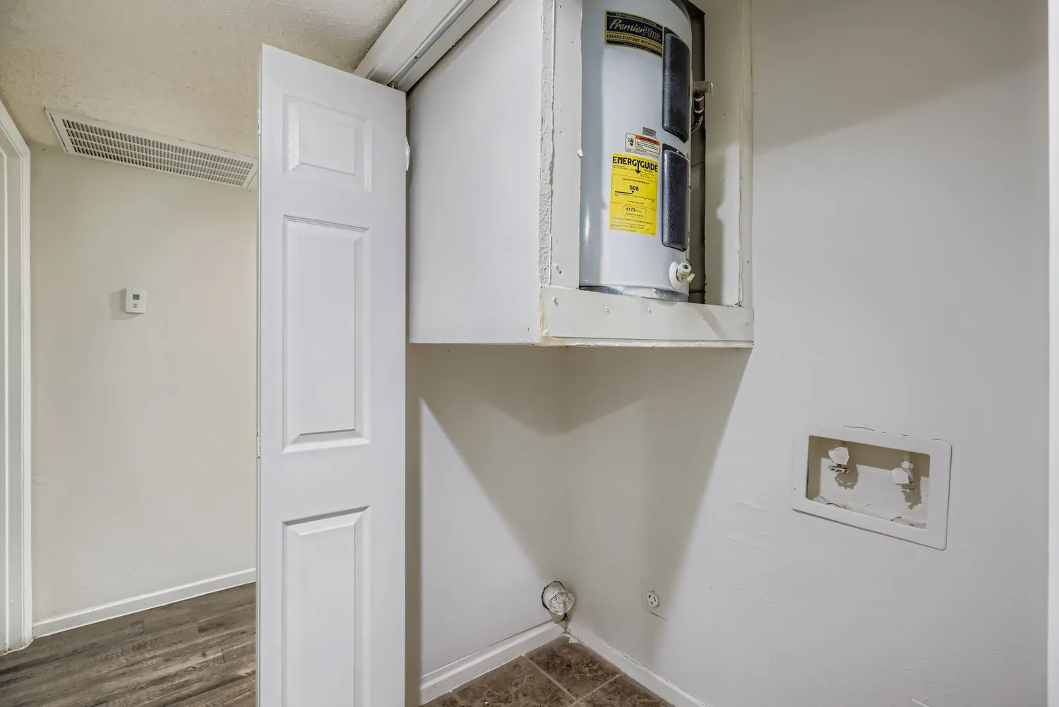 Laundry closet with water heater and washer/dryer hookups