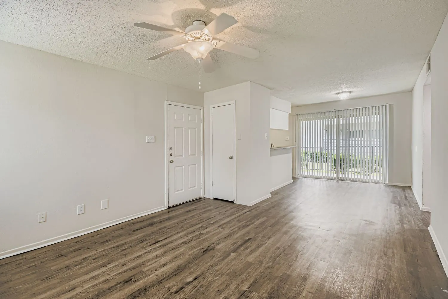 B2 Classic floor plan living room with wood-style plank flooring and sliding glass door