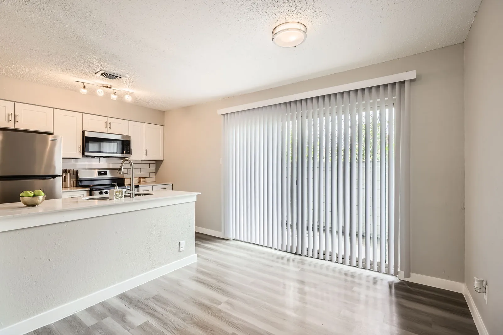 Breakfast area with kitchen bar seating and sliding glass door