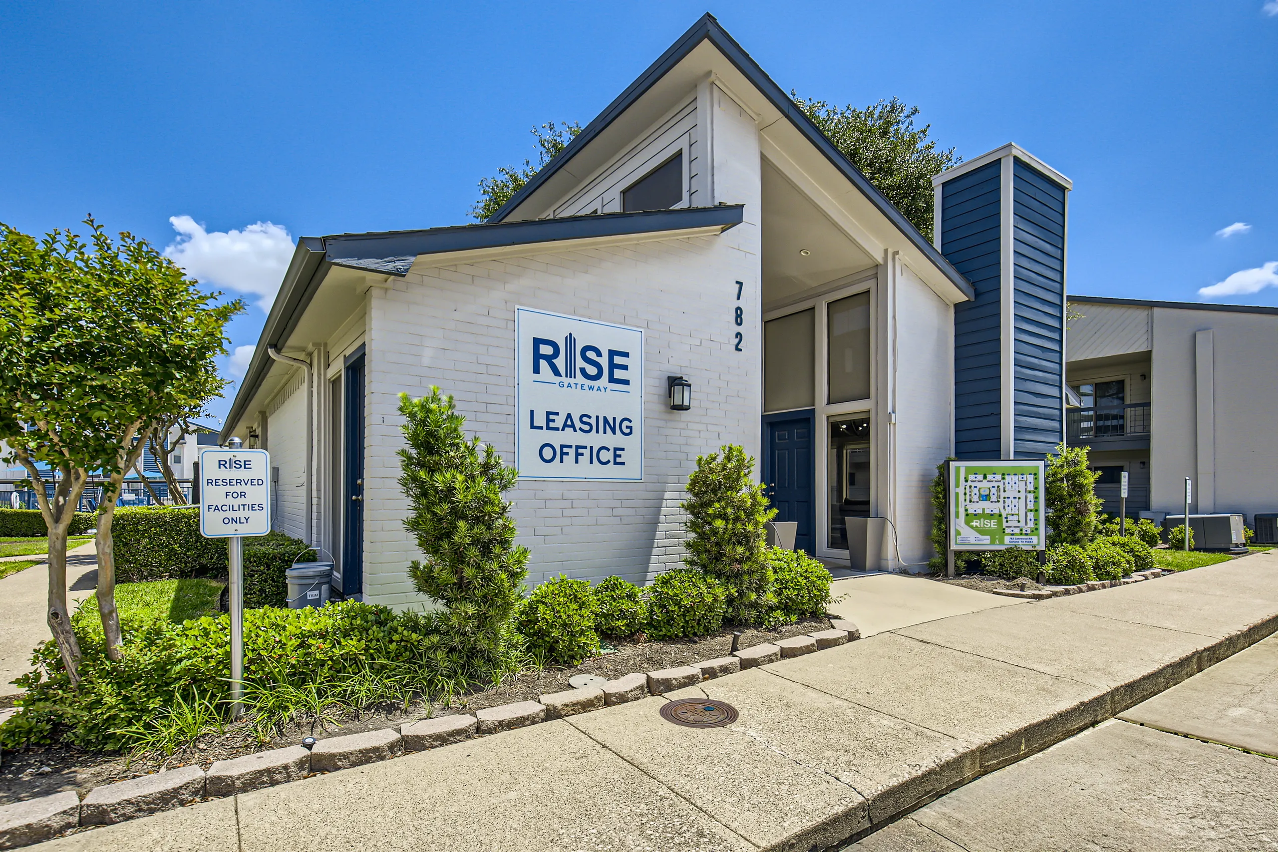 Rise Gateway apartments leasing office entrance with signage and landscaping