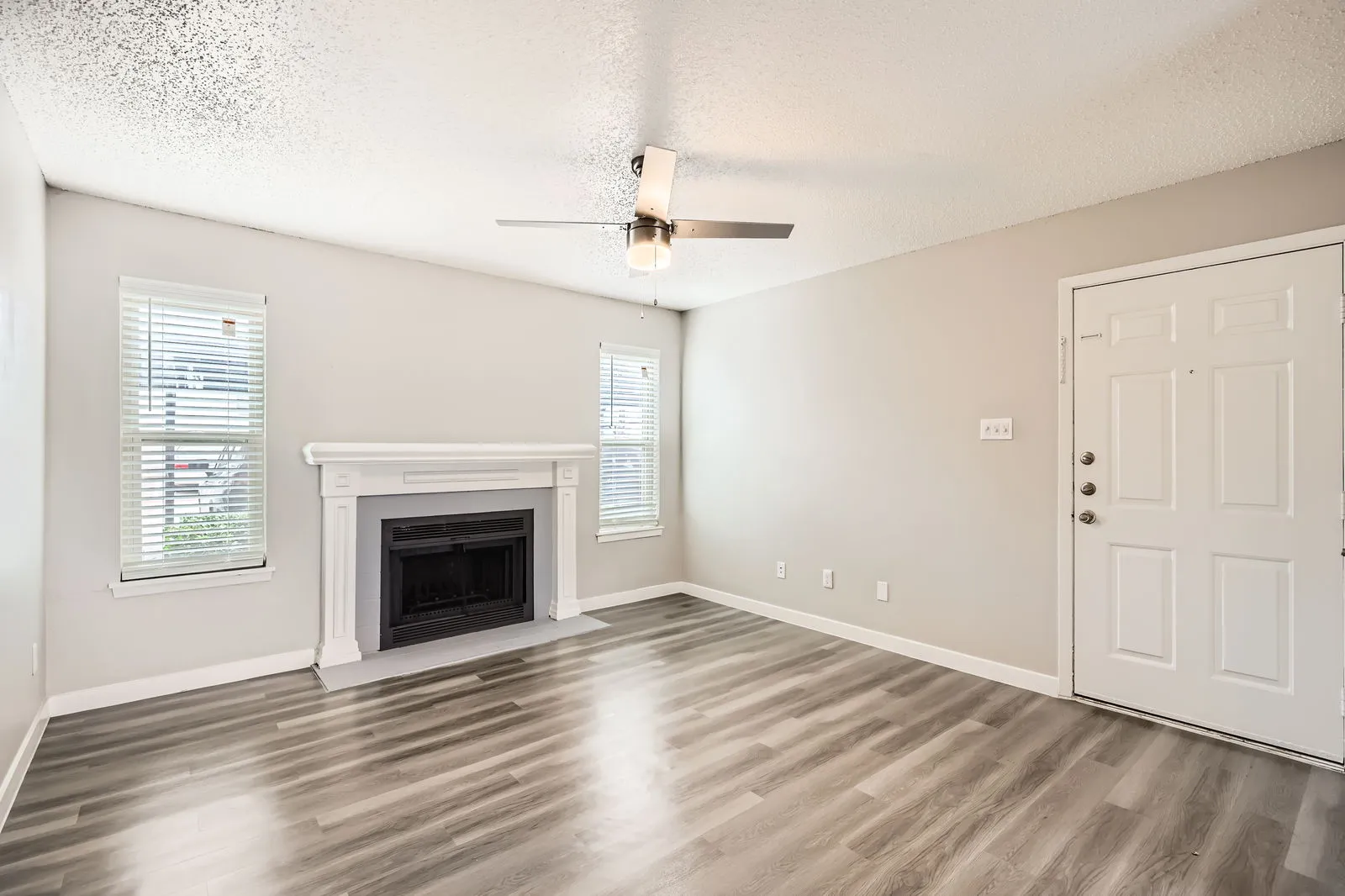 B2 Platinum floor plan living room with fireplace and wood-style plank flooring