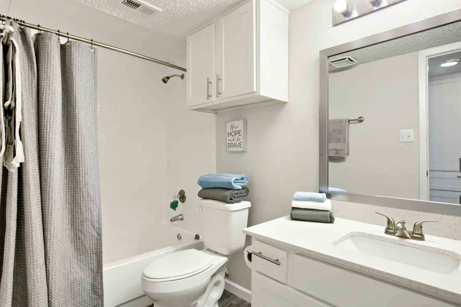 Bathroom vanity with tub and shower featuring shower curtain