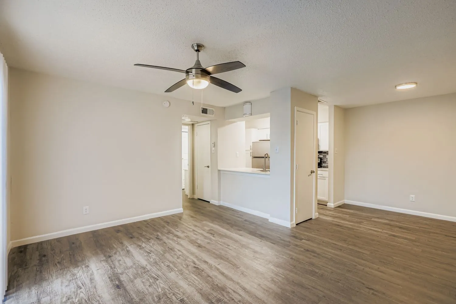 Open living room with view into kitchen and hallway
