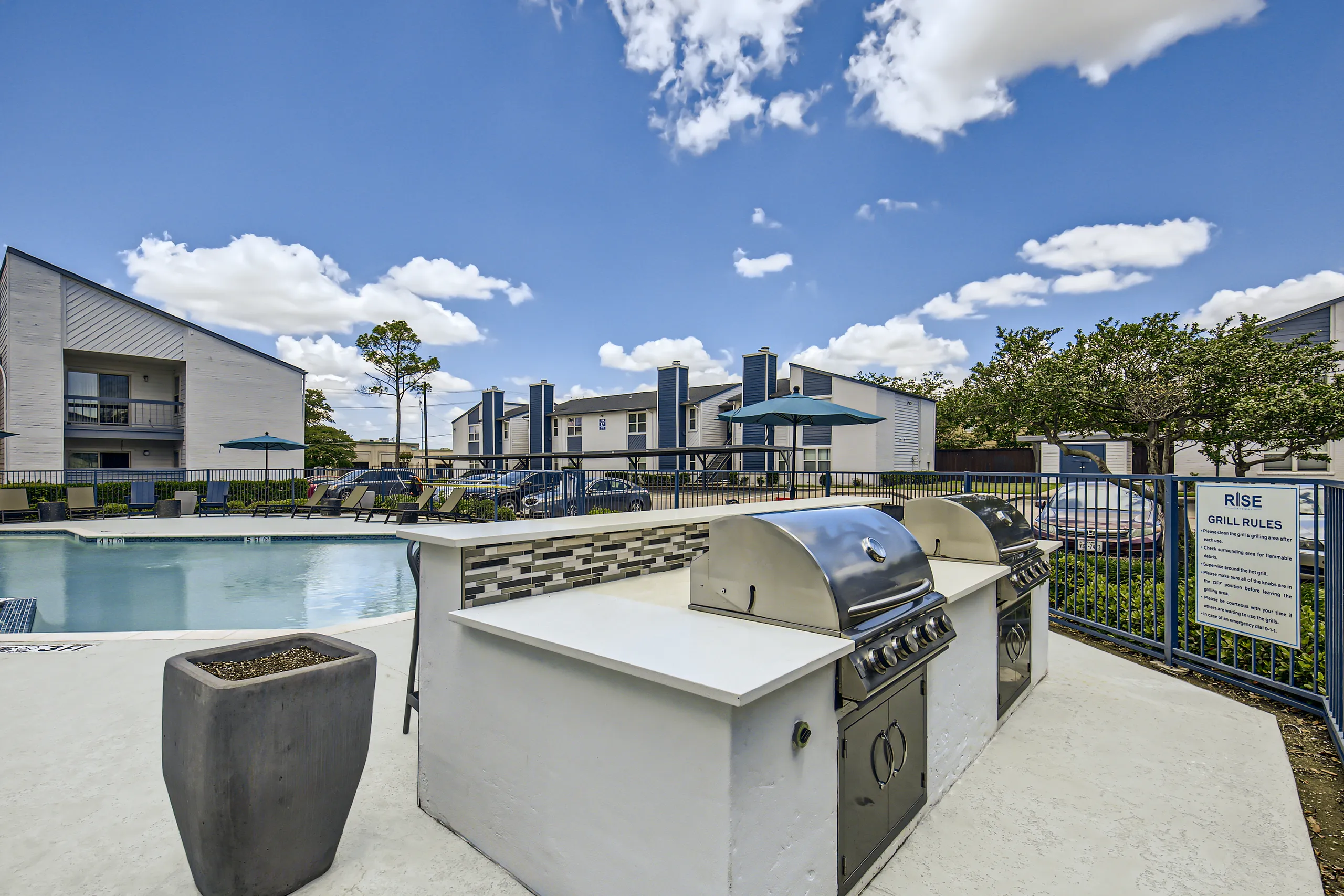 Stainless steel grills at outdoor kitchen station near the pool